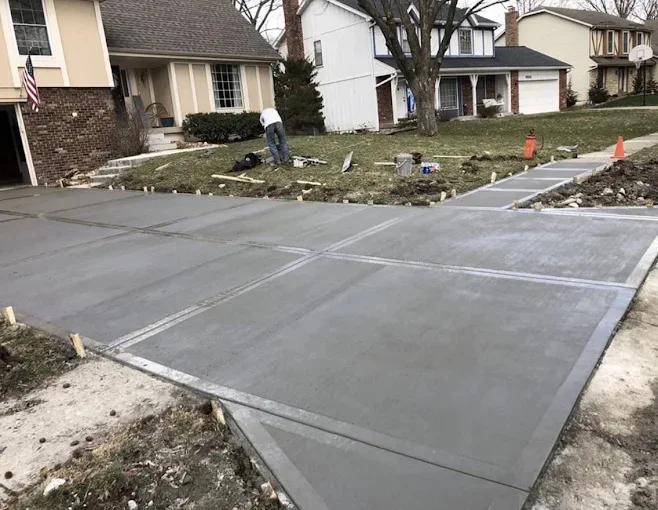 Freshly finished concrete driveway with control joints