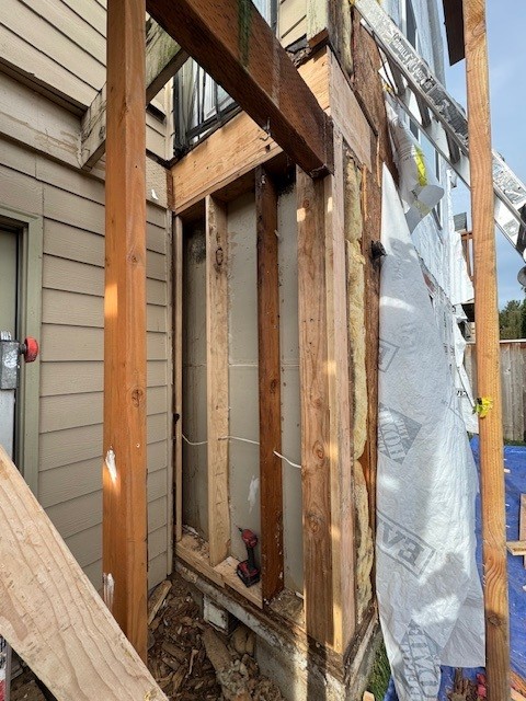 Exterior wall opened for structural dry rot remediation