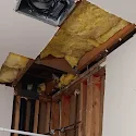Bathroom ceiling opened for plumbing and vent repair with new framing and insulation